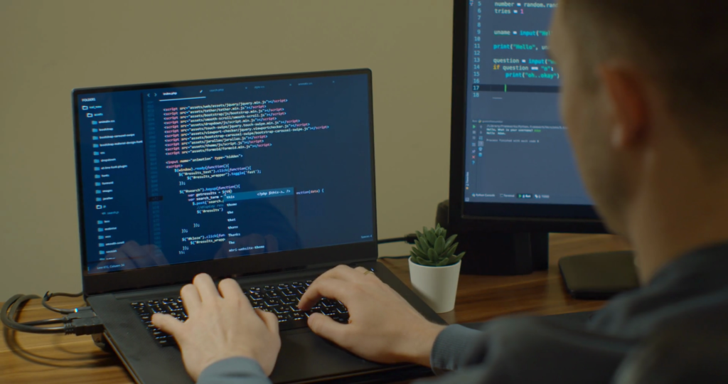 man typing on a computer